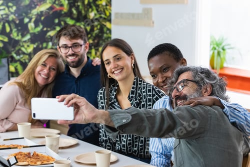 Preview: Selfie of a group of happy business people taking photo with a phone
