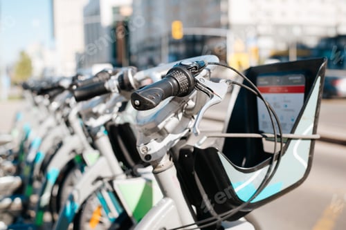 Preview: Bicycles for rent. Close-up of parked bicycles outdoors, selective focus on handlebars