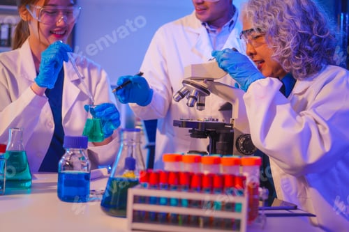 Preview: Two Asian men and women sit at a table in a laboratory, conducting research on liquids. They use