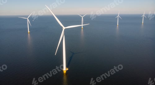 Preview: Windmill turbines at sea seen from a drone aerial view from above at a huge winmill park