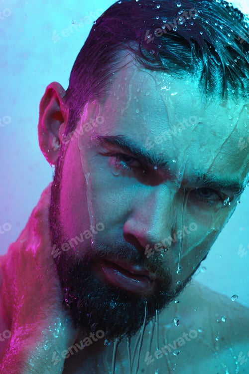 Preview: Portrait of handsome man under water flow in neon light