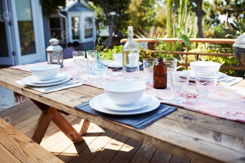 Preview: Table Set For Outdoor Meal On Wooden Table In Garden