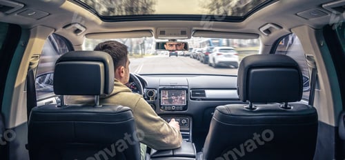 Preview: A male driver drives at speed through the streets of the city.