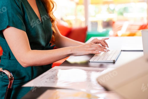 Preview: Beautiful caucasian business woman working in a coworking company office at computer desk