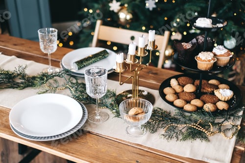 Preview: Festive Christmas table in the kitchen with a large Christmas tree and decorations.