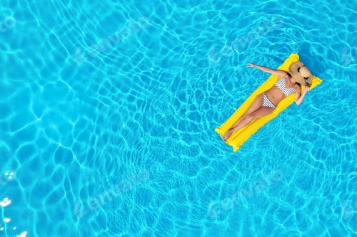Preview: Young woman with inflatable mattress in swimming pool, top view. Space for text