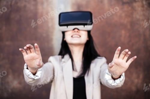 Preview: chinese Businesswoman using virtual reality headset. selective focus on hands. technology