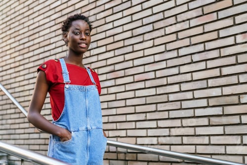 Preview: Young black African model woman walking down the stairs of her house doorway going out to the street