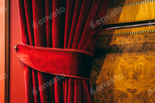 Preview: Red velvet curtain of a theater.