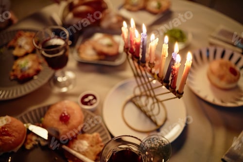 Preview: Hanukkah Menorah Candles Burning during Festive Meal Celebration with Food