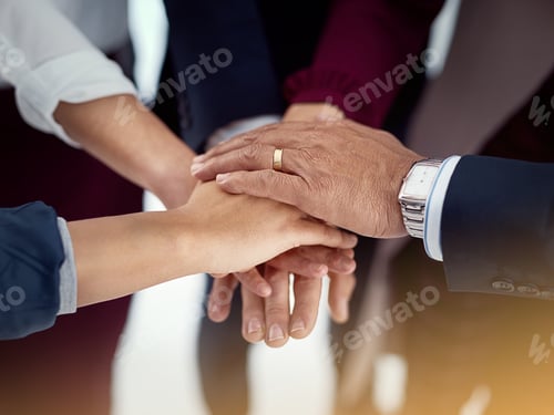 Preview: Cropped shot of a diverse team of colleagues joining their hands together in unity