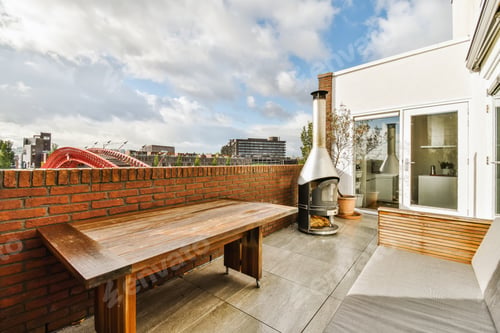 Rooftop Patio With Modern Fireplace and City View