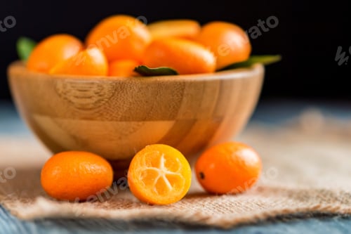 Preview: Kumquat or cumquat on wooden table