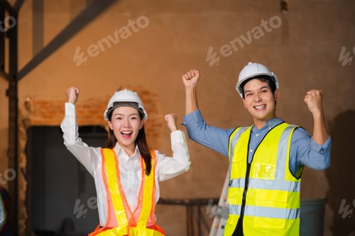 Preview: Successful engineer teams working together wear worker helmets hardhat on construction site.