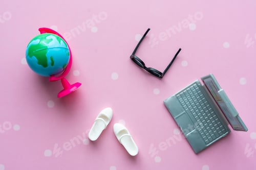 Preview: Toy black glasses, white boots, laptop and globe close-up. Back to school concept