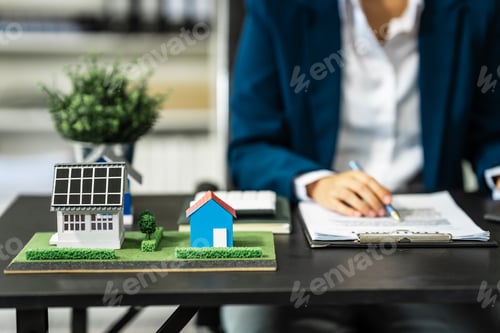 Preview: Real Estate Agent at Desk Reviewing Home Plans