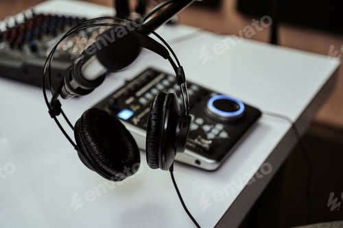 Preview: Working place of radio host. Close up of headphones, microphone and sound mixing desk on