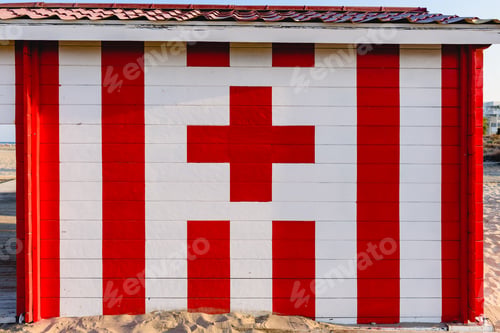 Preview: red cross cabin in summer on a beach