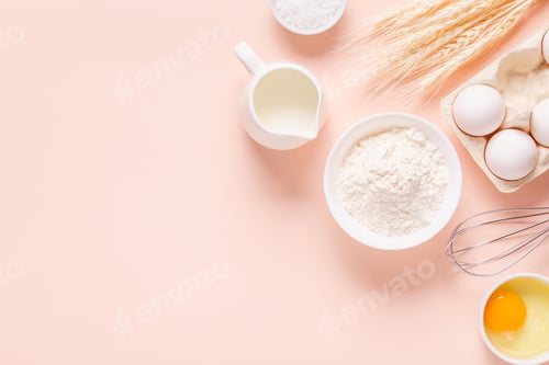 Preview: Ingredients for baking on light pink background.