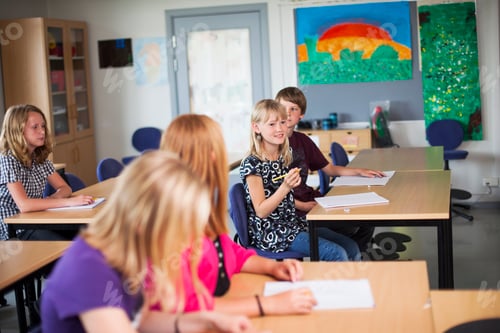 Preview: Junior high students sitting at desks in classroom