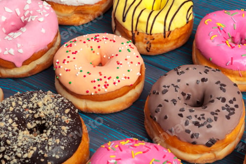 Preview: Colorful donuts assortment background top view close up