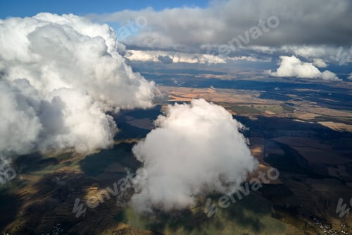 Preview: Aerial view at high altitude of earth covered with puffy cumulus clouds forming before rainstorm