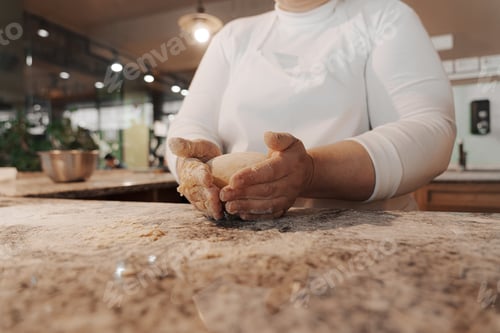 Preview: Crop cook kneading dough on counter