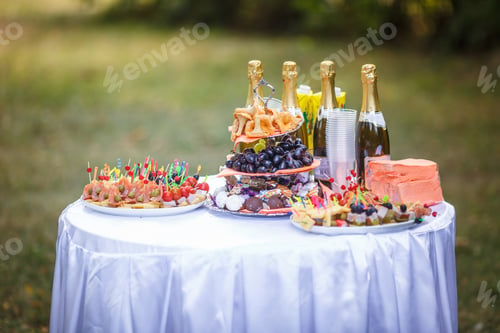 Preview: Decorated beautiful table at the celebration in park. Wedding.