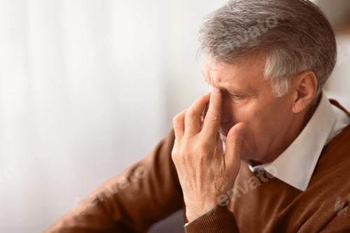 Preview: Desperate Elderly Man Thinking Sitting On Couch At Home
