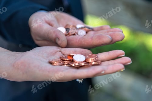 Preview: The bride and groom there with a handful of coins.