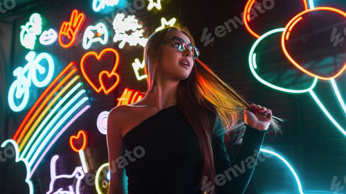 Preview: Beautiful woman in black clothes with sunglasses on a background with multicolored neon signs lights