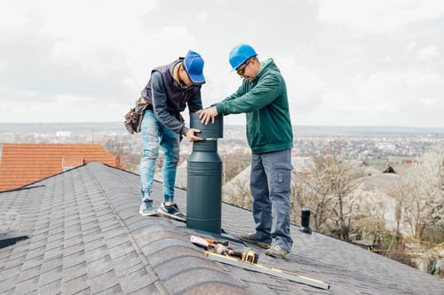 Preview: two professional masters Roofer construction workers repairing chimney