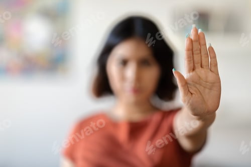 Preview: Stop Domestic Violence. Serious Young Woman Showing Open Palm Gesture At Camera