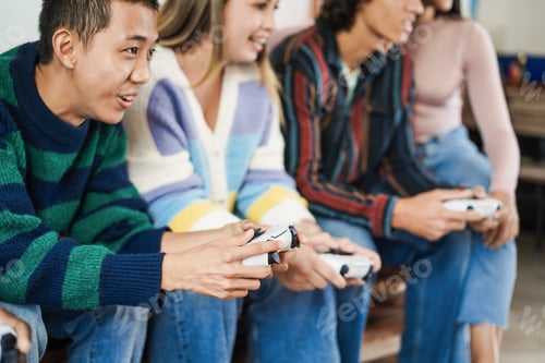 Preview: Multiracial young friends having fun playing video games at home - Focus on asian boy hand
