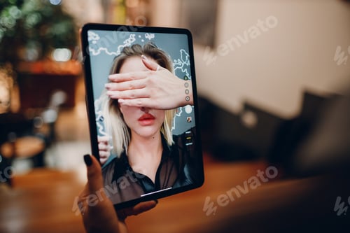 Preview: Young woman taking selfie on a digital tablet