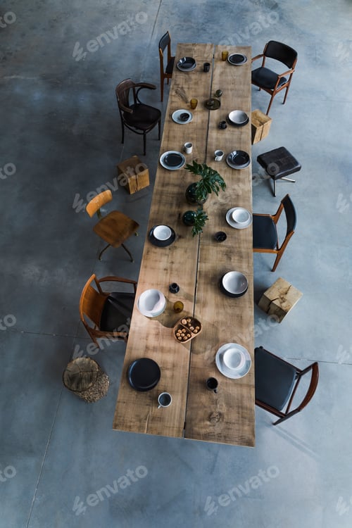 Preview: Elegant rustic wooden dining table. Stylish top view composition of tableware and porcelain.