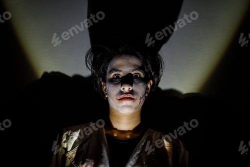 Preview: Halloween portrait of a terrifying girl with a dark shadow in the background