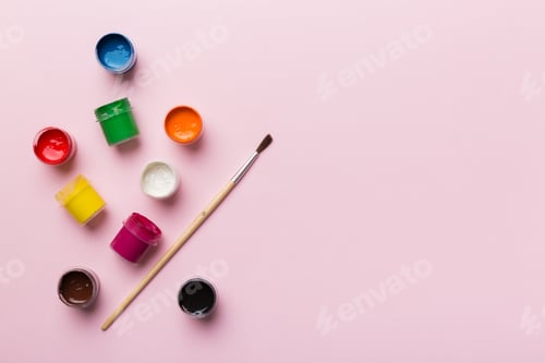 Preview: art palette with paint and brushes, close up. Top view with empty space. workplace