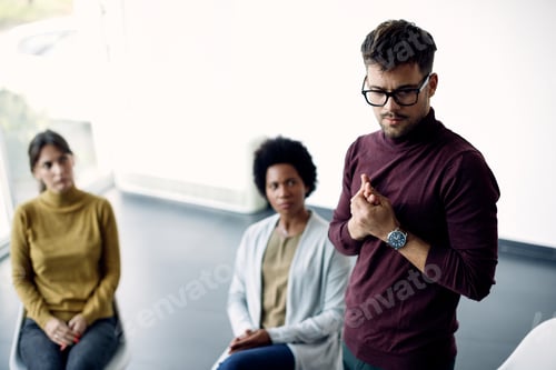 Preview: Anxious man talking about his issues during group therapy.