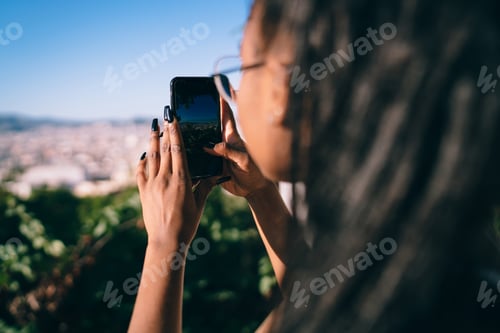 Preview: dark skinned female blogger shooting mobile video vlog via cellular application