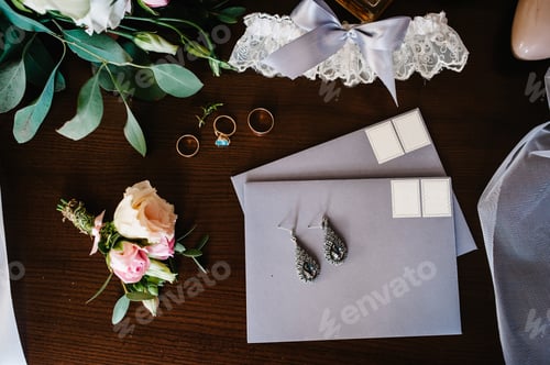 Preview: Wedding accessory bride. Stylish beige shoes, earrings, gold rings, flowers, garter, perfumes on tab