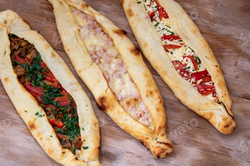 Preview: Closeup shot of delicious flatbread pockets with different fillings