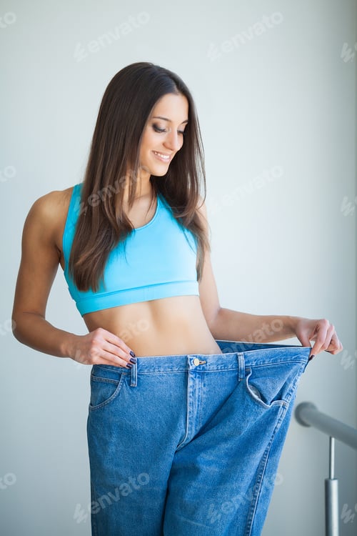 Preview: Diet. Woman shows her weight loss and wearing her old jeans