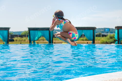 Preview: The child jumps dives into the pool. Selective focus.