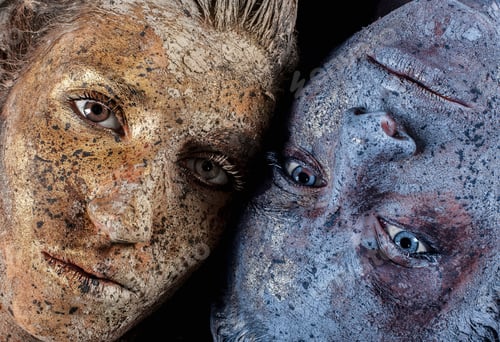 Preview: Cropped view of paint covered young women looking at camera