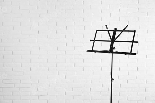 Preview: Empty music note stand near brick wall. Space for text