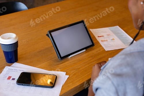 Preview: Plus size african american casual businesswoman making video call using tablet, copy space in office