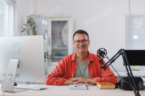 Preview: Mature man smiling creating podcast content