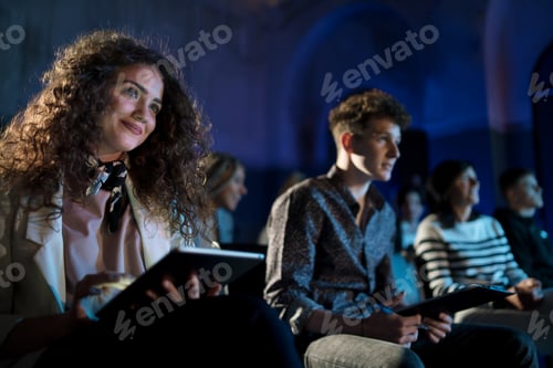 Preview: Group of people making notes while listening to presentation at conference