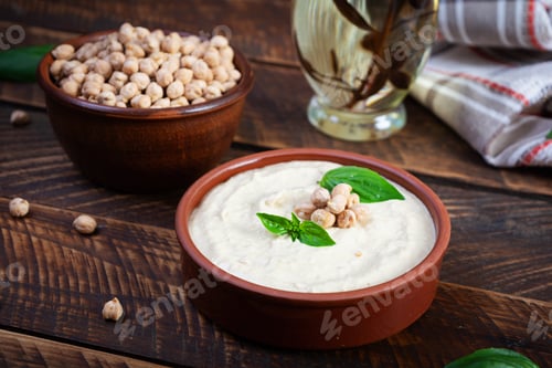 Preview: Eggplant hummus in a plate with basil. Chickpea dishes. Vegetarian food